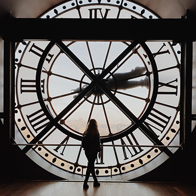 woman in front of giant clock